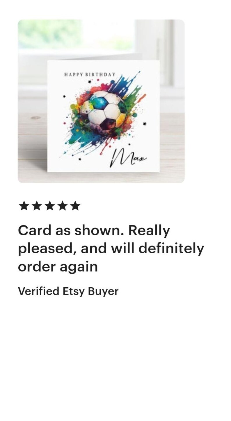 May include: A white card with a colorful watercolor design of a soccer ball. The text "HAPPY BIRTHDAY" is at the top of the card and the name "Max" is written in cursive at the bottom.