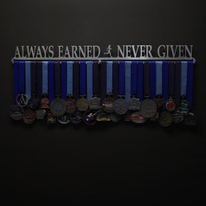 May include: A metal medal display rack with the words "ALWAYS EARNED NEVER GIVEN" and a running figure silhouette. The rack is filled with a variety of silver, bronze, and gold medals with different designs.
