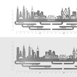 May include: A silver metal medal display hanger featuring the World Marathon Majors skyline silhouette. The design includes the text World Marathon Majors and city names Chicago, New York, Boston, London, Berlin, and Tokyo. Available in 45.7 cm and 63.2 cm widths.