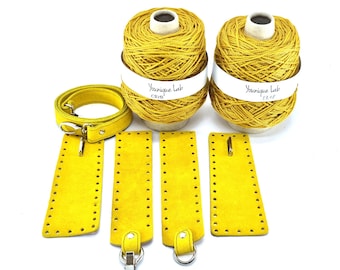 May include: A collection of yellow craft supplies, including two spools of yarn with white labels, several yellow leather pieces with holes, and a yellow belt with silver hardware. The yarn spools have the text "Younique Lab" on the labels.