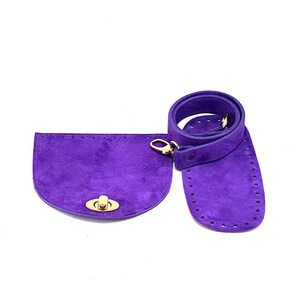 May include: A purple suede bag base and matching strap set. The bag base is a half-circle shape with a gold-colored clasp. The strap is a matching purple color and has a gold-colored clasp.