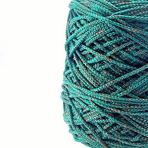 May include: A spool of teal green yarn with gold metallic thread woven throughout.