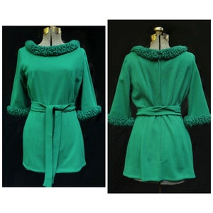 May include: A green dress with a fluffy collar and cuffs. The dress has a belt and a slightly A-line shape.