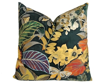 May include: A decorative pillow with a dark green background and a colorful floral pattern. The pattern features yellow, orange, red, and purple flowers, leaves, and butterflies.