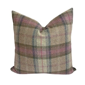 May include: A brown, pink and green plaid cushion with a soft, textured fabric.