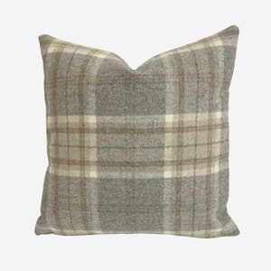 May include: A gray and brown plaid throw pillow with a soft, textured fabric.