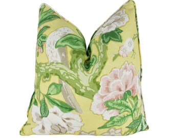May include: A yellow throw pillow with a floral pattern featuring pink and white flowers, green leaves, and a gray bird on a branch.