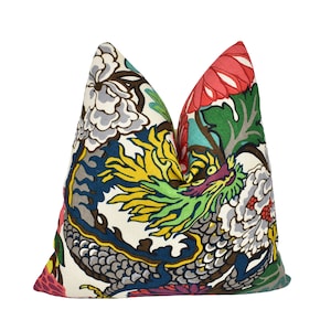 May include: A colourful throw pillow featuring a dragon and floral design. The pillow is made from a soft, durable fabric and incorporates a range of colours, including red, green, yellow, blue and white.