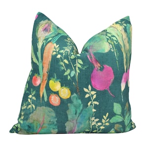 May include: A teal green cushion with a watercolour print of vegetables, including carrots, radishes, and tomatoes.