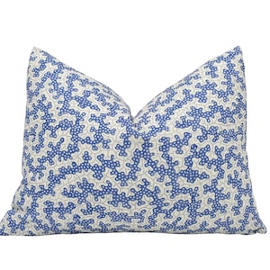 a blue and white pillow on a white background
