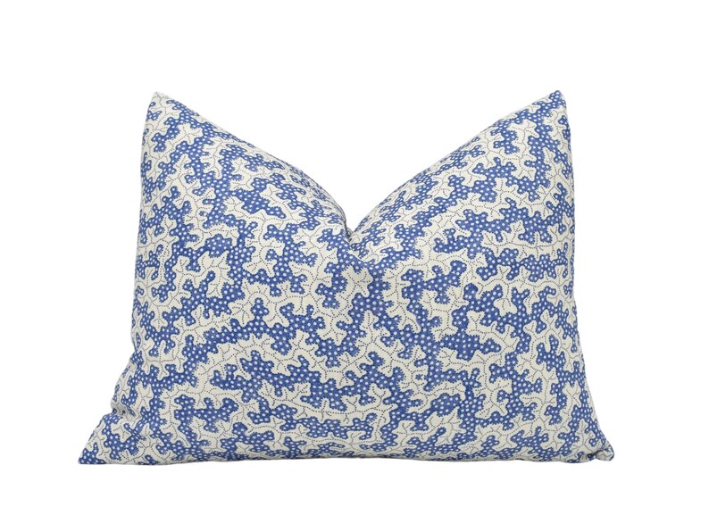 a blue and white pillow on a white background