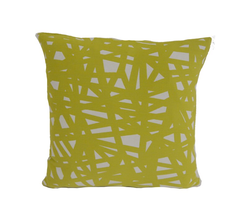 May include: A yellow throw pillow with a white geometric pattern. The pillow is made of a soft, comfortable fabric and is perfect for adding a touch of style to any room.