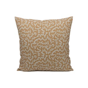 May include: A square throw pillow with a beige background and a brown coral-like pattern.