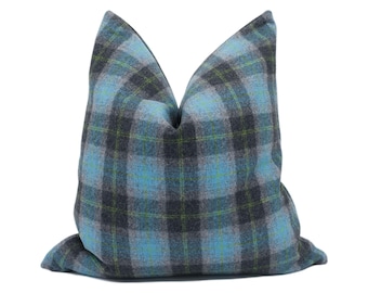 May include: A blue and gray plaid throw pillow with a soft, textured fabric.