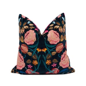 a blue pillow with pink flowers on it