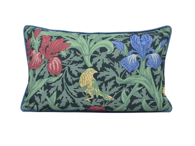 a pillow with a bird and flowers on it