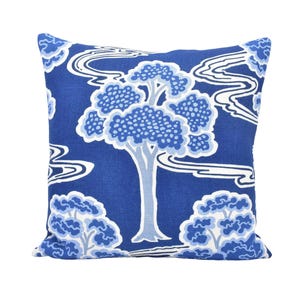 a blue and white pillow with a tree on it