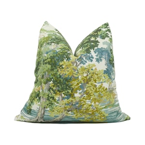 May include: A green and blue patterned throw pillow with a nature scene featuring trees and water. The pillow is made of a soft, comfortable fabric and is perfect for adding a touch of nature to your home decor.