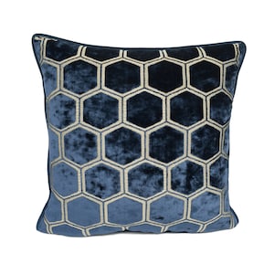 May include: A blue velvet throw pillow with a gold honeycomb pattern.