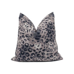 May include: A gray and black leopard print throw pillow with a square shape.