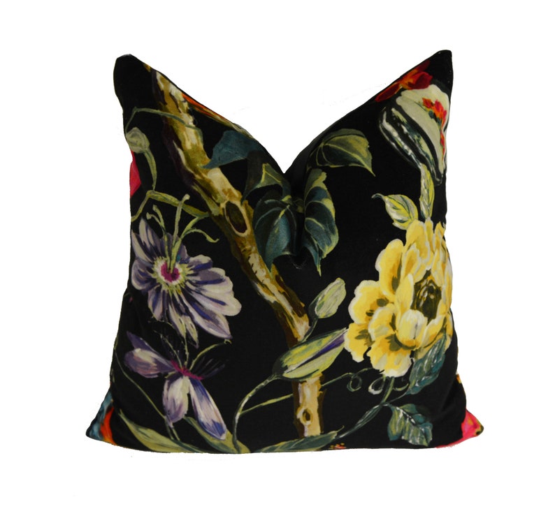 May include: Black velvet pillow with a floral print featuring yellow, red, pink, purple, and green flowers and leaves.