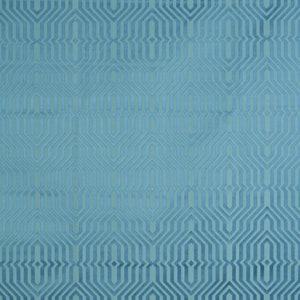 May include: A teal blue fabric with a geometric pattern of overlapping hexagons and diamonds.
