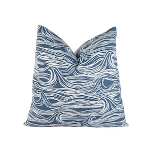 May include: A blue throw pillow with a white wave pattern.