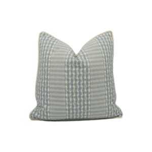 May include: A blue and white checkered throw pillow with a white border.
