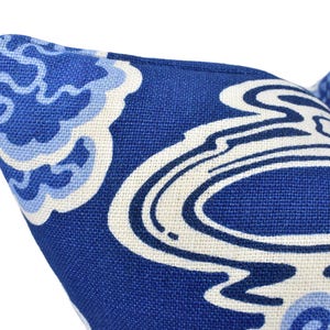 a close up of a blue and white pillow