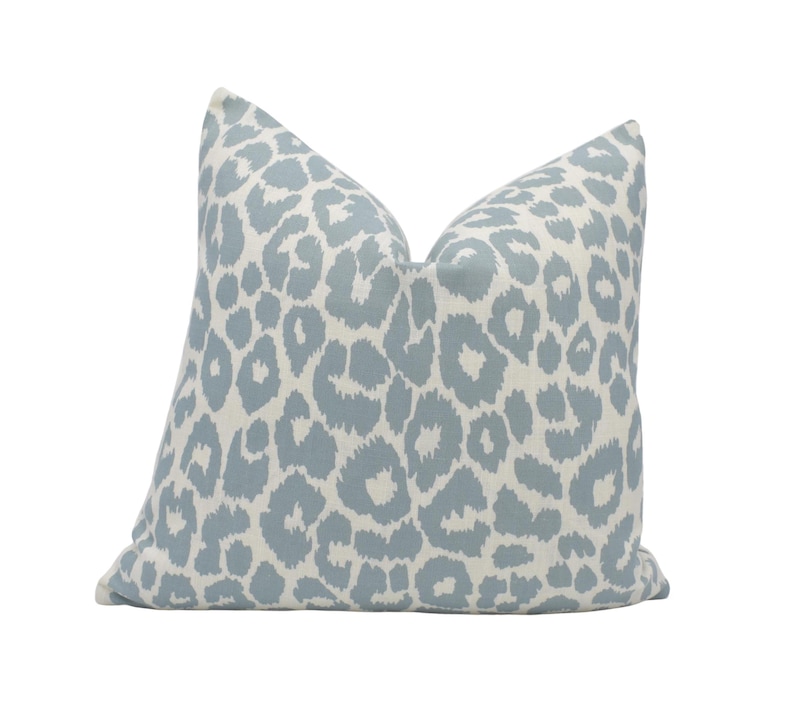 a blue and white pillow with a leopard print