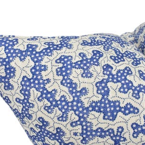 a close up of a blue and white pillow