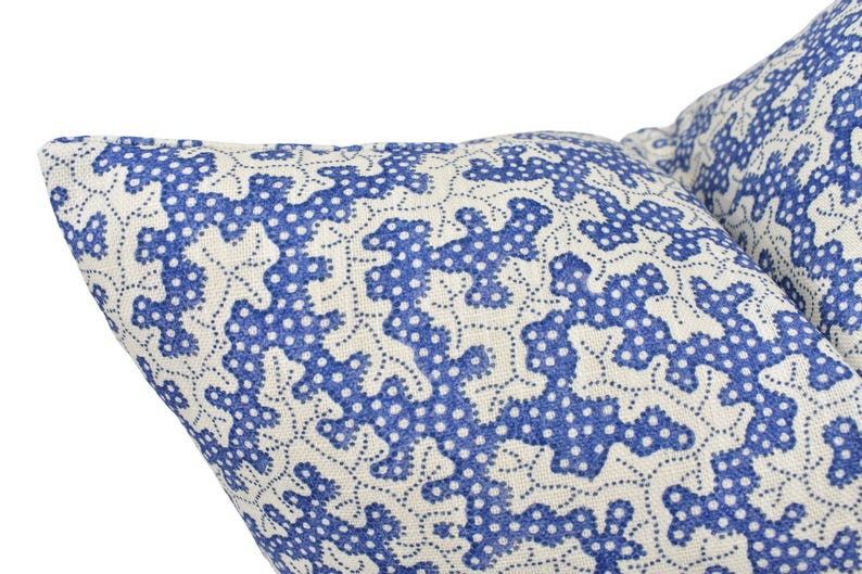 a close up of a blue and white pillow