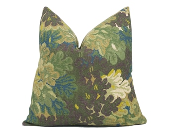 May include: A green, yellow, and blue floral patterned throw pillow. The pillow is made of a soft, woven fabric.