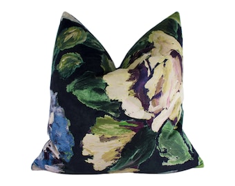 May include: A black pillow with a floral pattern in shades of green, blue, yellow, and pink. The flowers are painted in a brushstroke style.