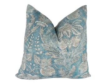 May include: A blue and beige patterned throw pillow with a floral design.
