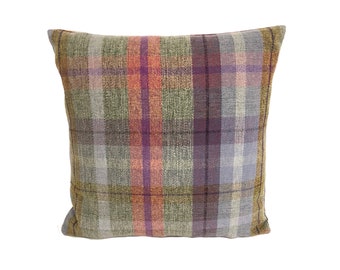 May include: A square throw pillow with a plaid pattern in shades of green, orange, purple, and gray.