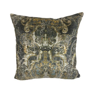 May include: A decorative throw pillow with a gold and black paisley pattern. The pillow is made of a soft, plush fabric.