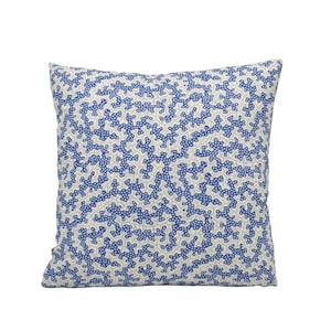 a blue and white pillow on a white background