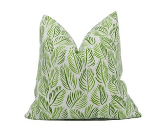 May include: A green and white throw pillow with a leafy pattern.