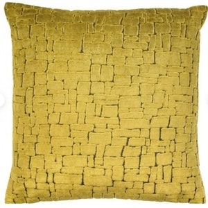 May include: A yellow throw pillow with a textured brick pattern.