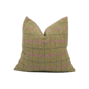 Puede incluir: Una almohada de tiro de cuadros verdes y rosas con una tela suave y texturizada.