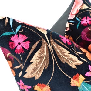 a close up of a flowered bag on a white background
