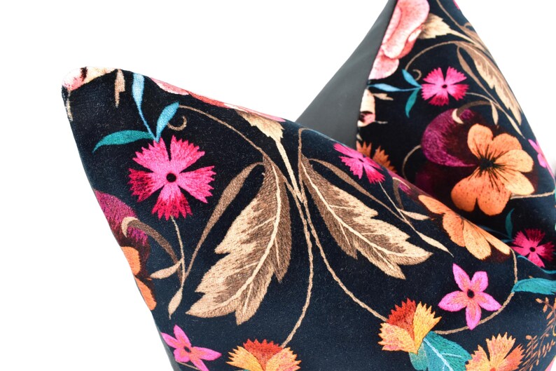 a close up of a flowered bag on a white background