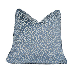 May include: A blue and white patterned cushion with a leopard print design.
