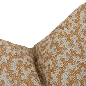 May include: Two brown and white patterned throw pillows with a geometric design.