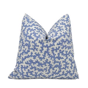 a blue and white pillow on a white background