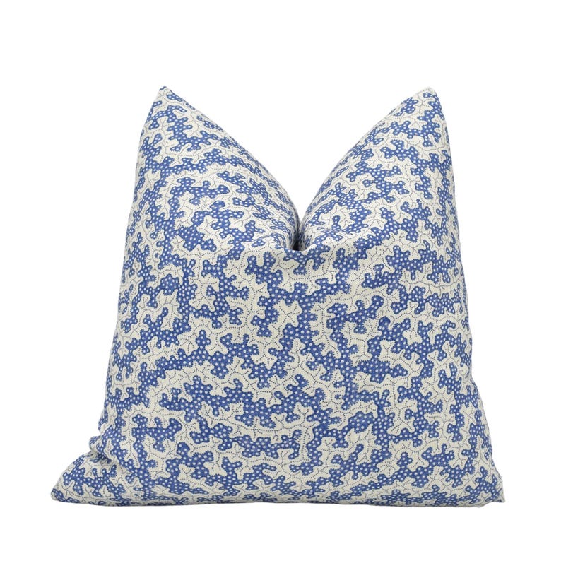 a blue and white pillow on a white background