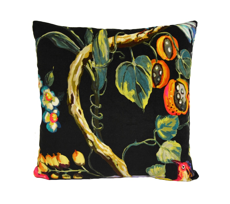 May include: Black throw pillow with a colorful floral pattern featuring a vine with leaves, flowers, and fruit. The pillow has a dark background with bright yellow, orange, red, and green accents.