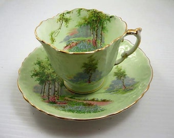 English Tea Cup & Saucer. Aynsley  Bone China.  Woodland Scene  Green Background with Gold Trim