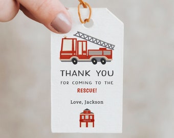 May include: Red and white thank you tag with a red fire engine and fire station illustration. The text reads "Thank you for coming to the rescue! Love, Jackson".
